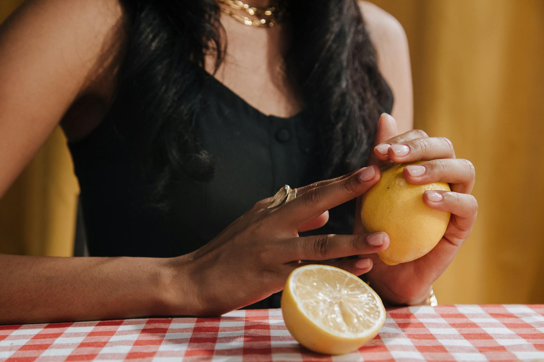 Woman holding a fresh lemon, representing the change and renewal of understanding sexual pleasure across decades.