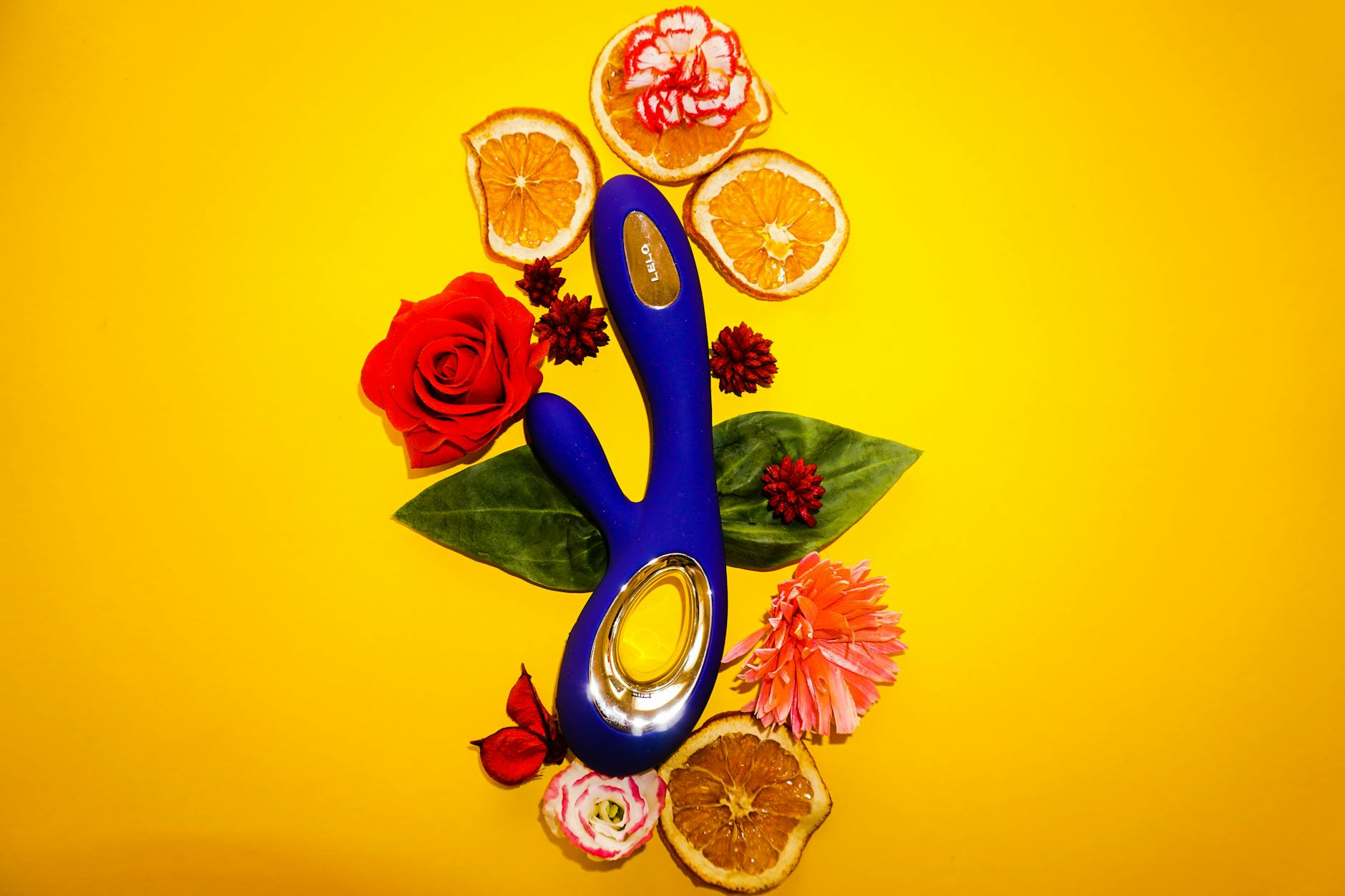Hands holding a blue clitoral vibrator, representing solo pleasure and self-intimacy after relationship transition